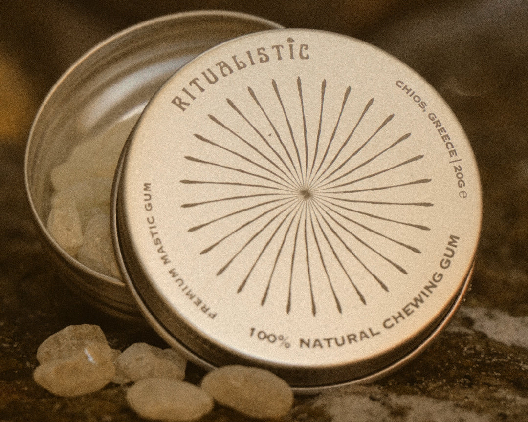 Open Ritualistic tin with mastic tears on warm stone.